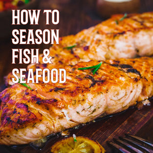Grilled seasoned salmon steaks on a wooden board with text 'How to Season Fish & Seafood'.