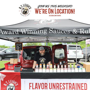 B.T. Leigh's Sauces and Rubs outdoor event booth with sauces displayed, vendor under branded tent.