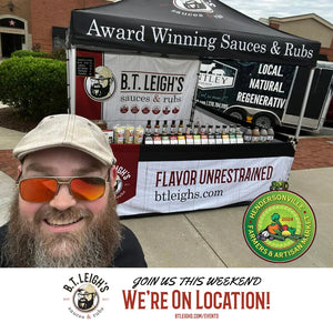 B.T. Leigh's Sauces and Rubs booth at Hendersonville Farmers Market with smiling vendor.
