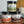 Three jars of B.T. Leigh's seasoning on a wooden surface with a blurred background