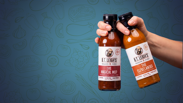 Two hands holding bottles of B.T.