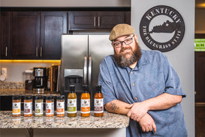 Brian Leigh of B.T. Leigh's Sauces and Rubs poses with their product lineup